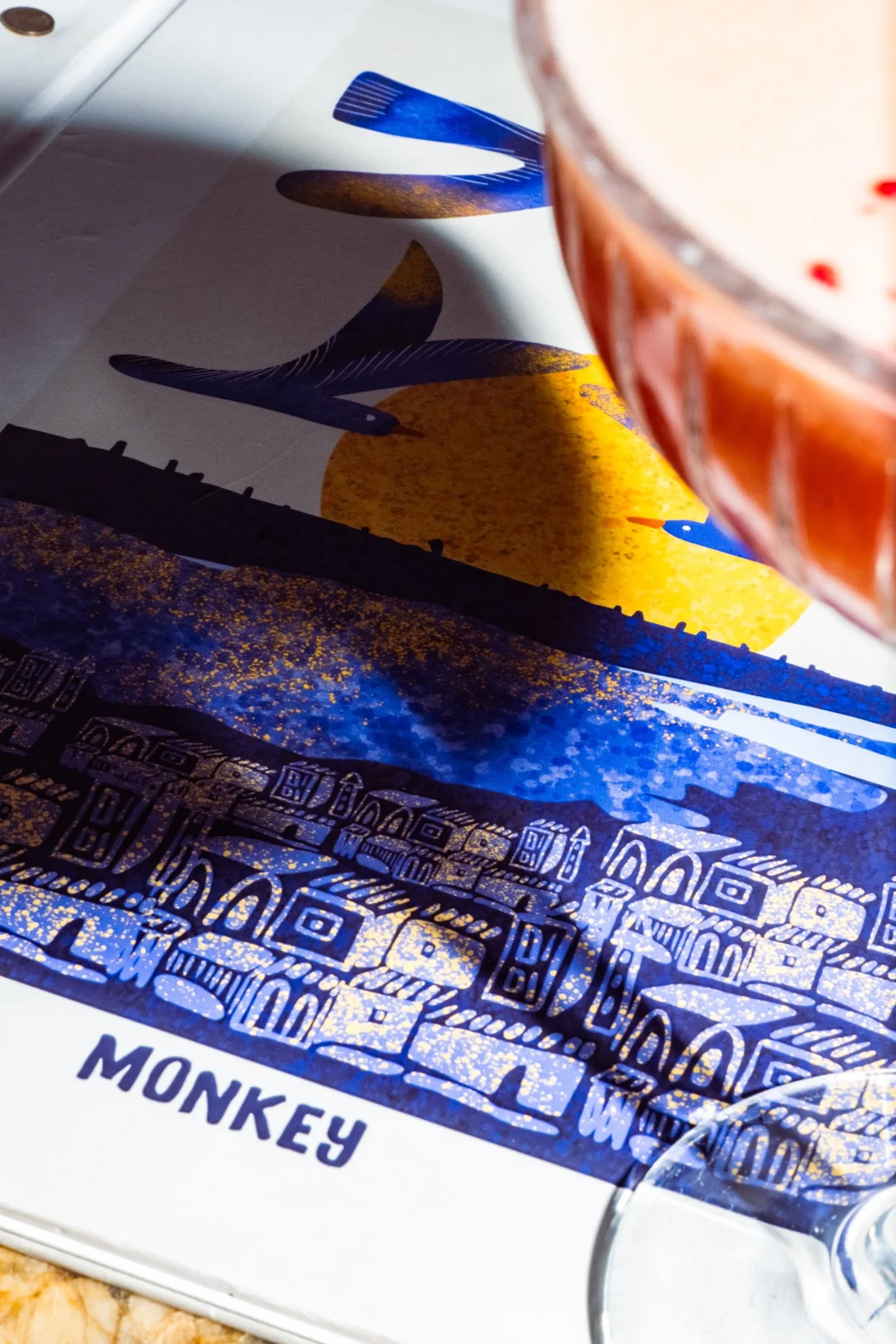 A detail of the Monkey illustrated menu and glassware