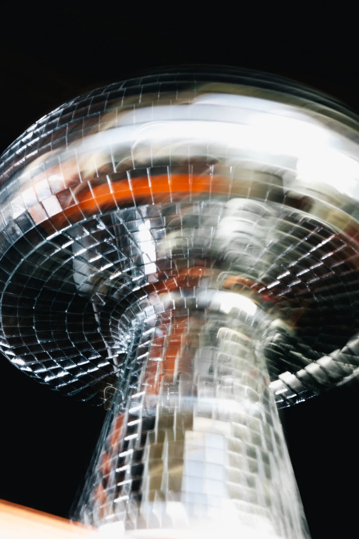 A mirrored disco ball captured in motion