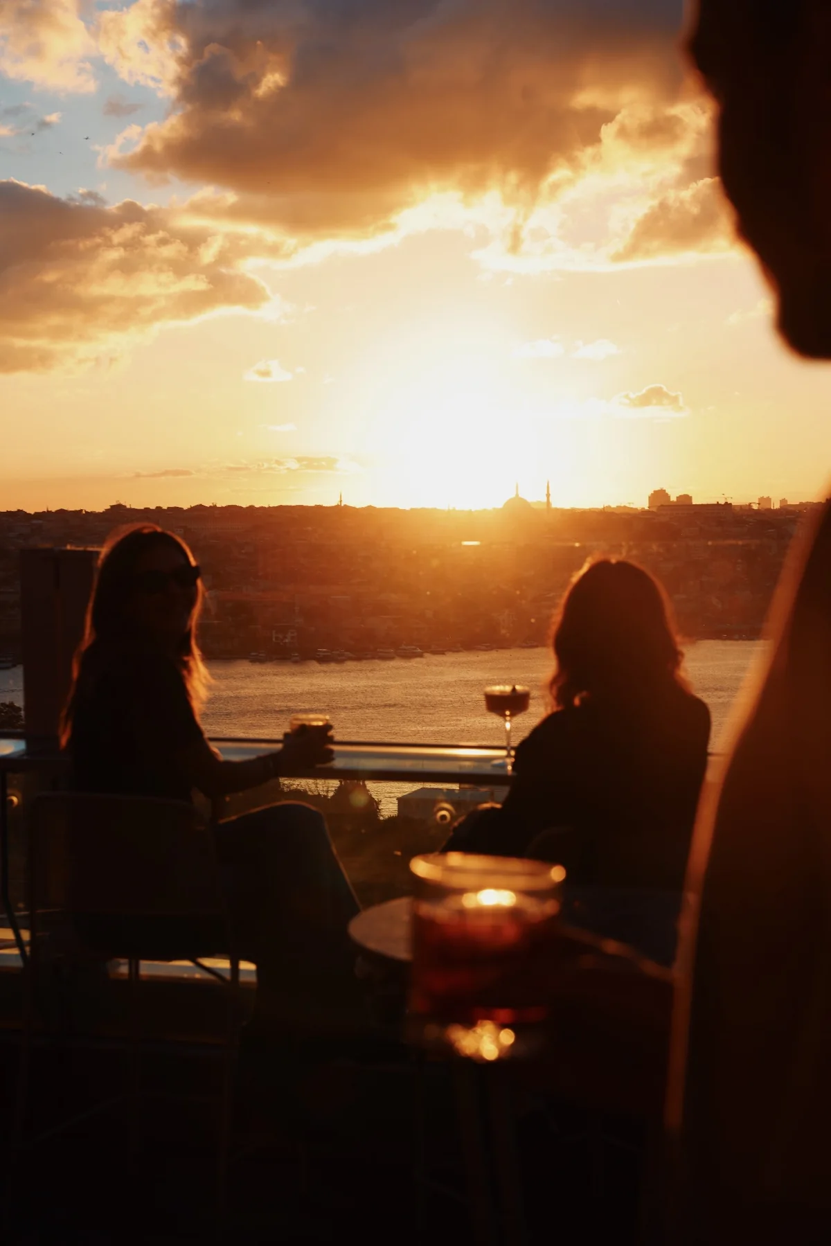 A conversation over drinks as the sun sets over the Golden Horn
